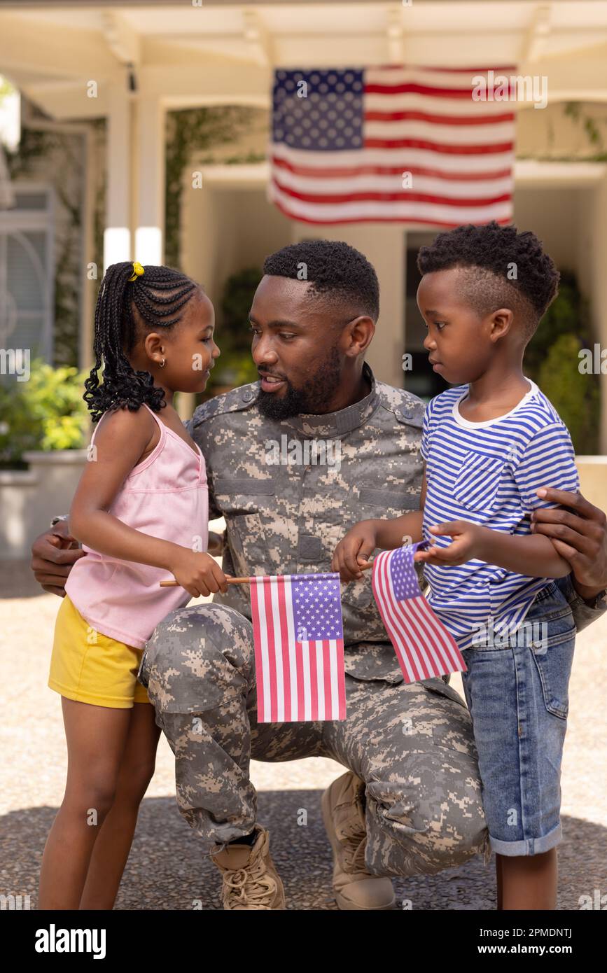 African american army soldier father embracing and talking with children outside house Stock Photo