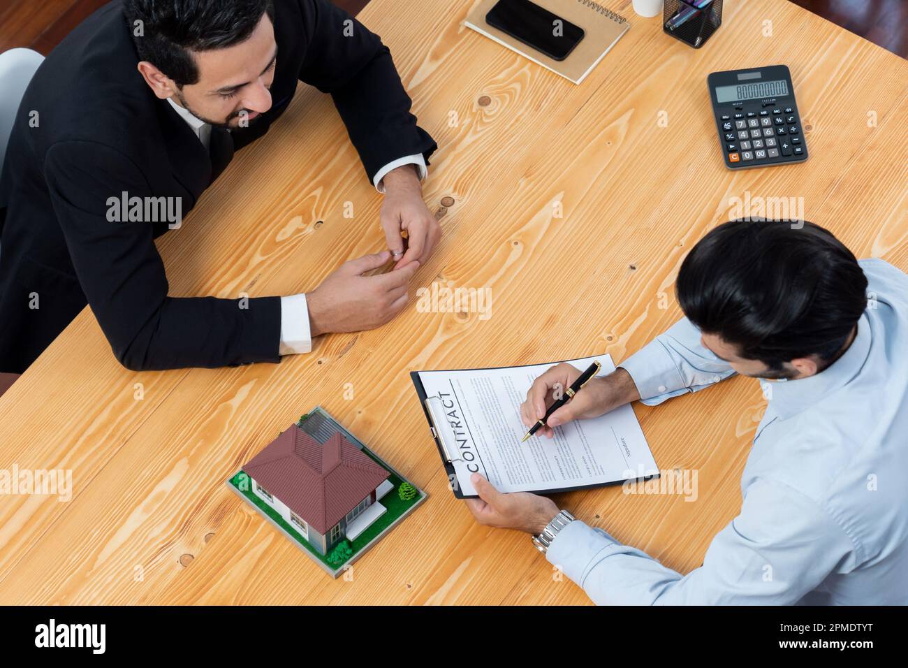 Top view real estate agent calculate tax and interest, discuss