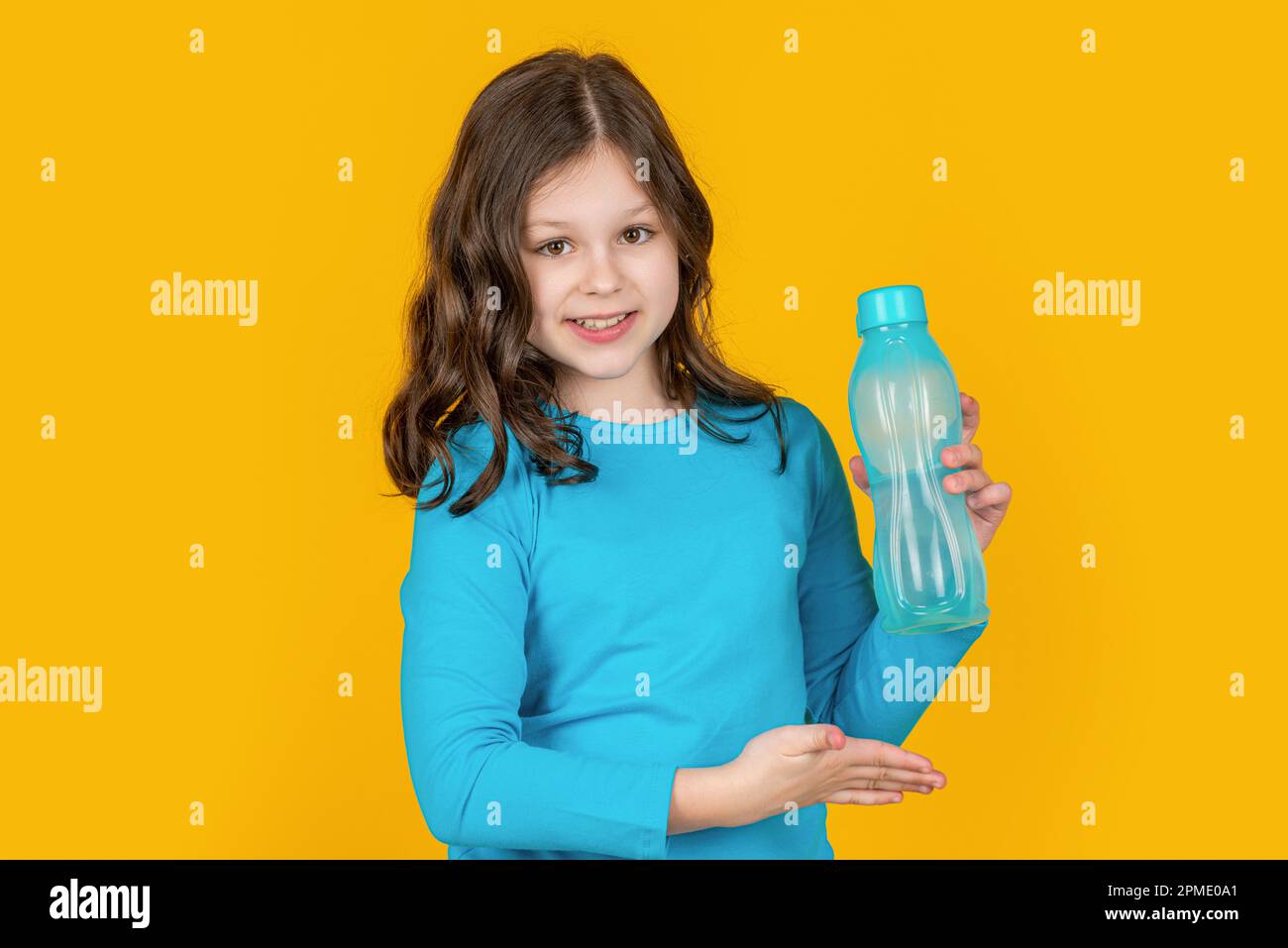 https://c8.alamy.com/comp/2PME0A1/child-presenting-sport-bottle-on-yellow-background-2PME0A1.jpg