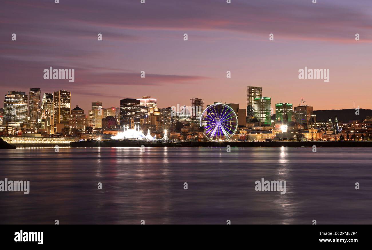 Montreal skyline at night reflected in St. Lawrence River, Quebec, Canada Stock Photo