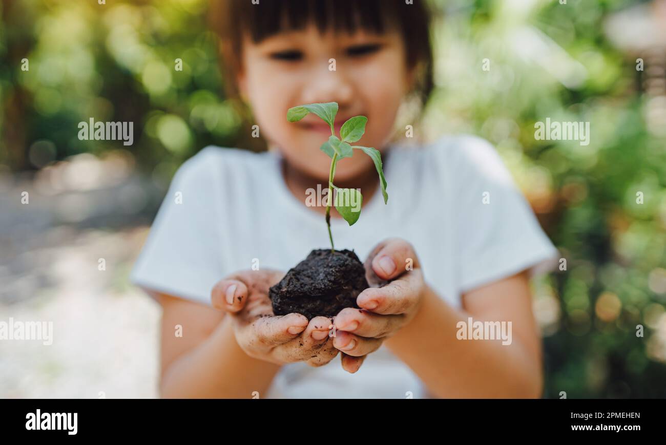 Cute kid planting a tree for help to prevent global warming or climate