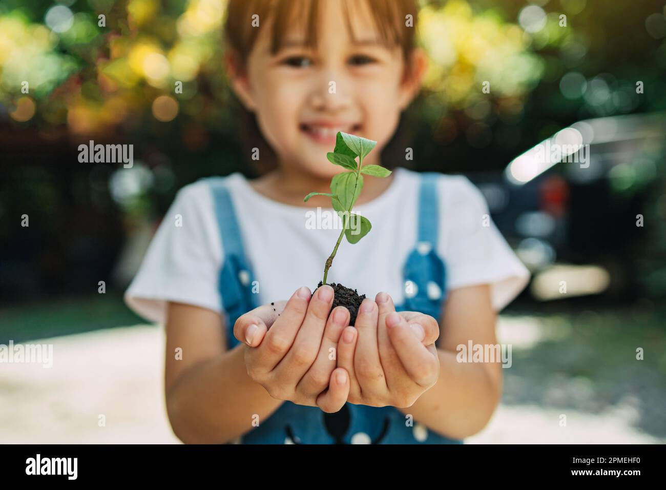 Cute kid planting a tree for help to prevent global warming or climate