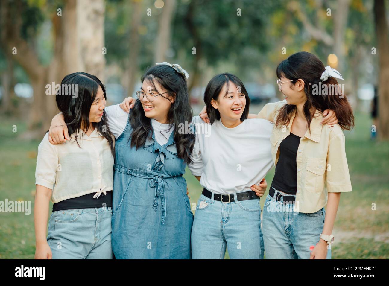Groups of friends embrace each other together. Concept for kindness support of people having fun with diversity millenials of gen z. Stock Photo