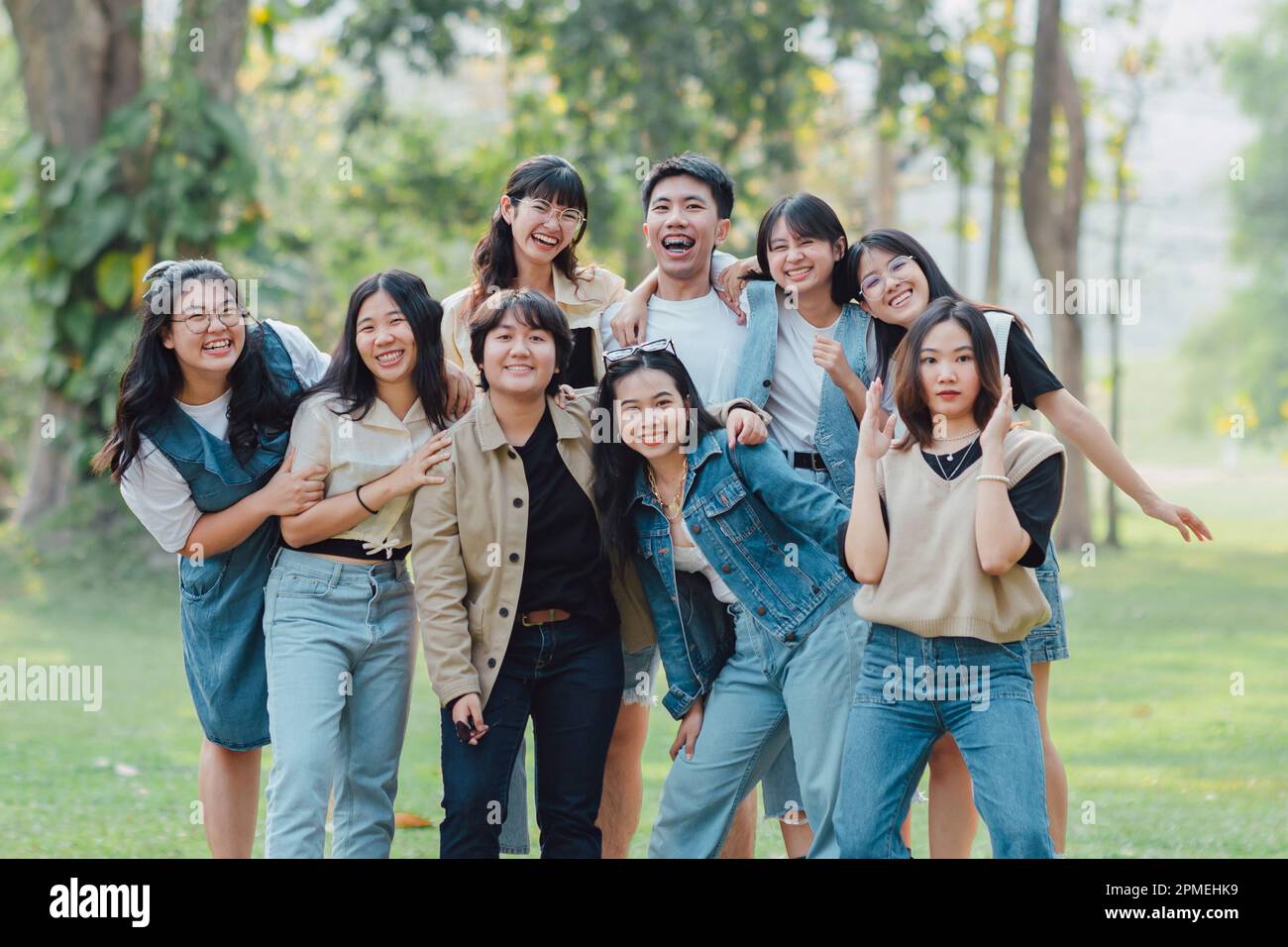Groups of friends embrace each other together. Concept for kindness support of people having fun with diversity millenials of gen z. Stock Photo