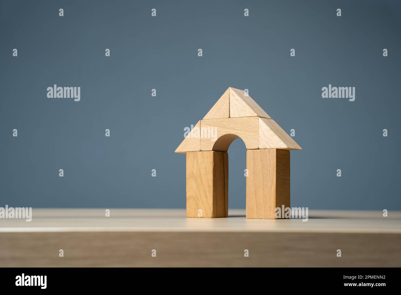 House with arch door with wooden blocks. Buying and selling housing. Design and architectural services. Property insurance. Real estate market review. Stock Photo