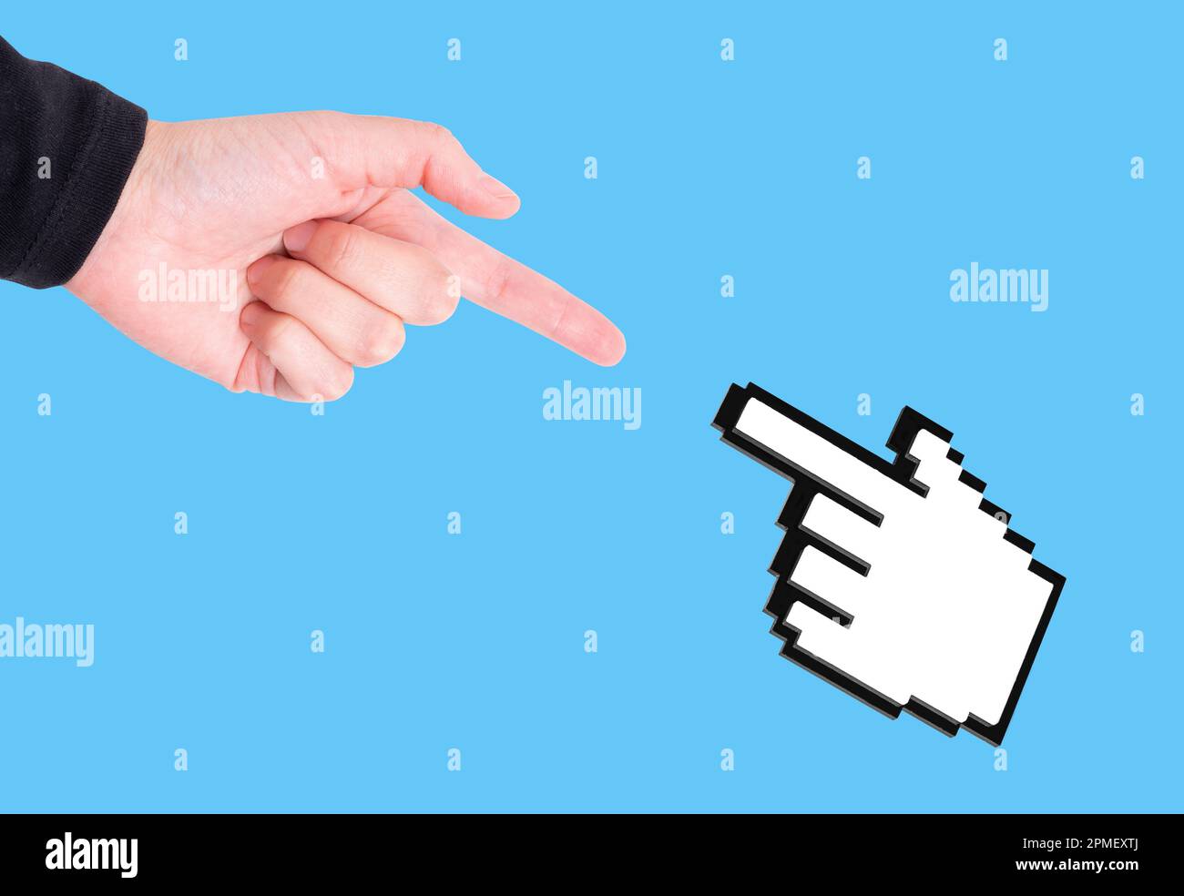 Hand pointing finger and a computer mouse pointer, both reaching