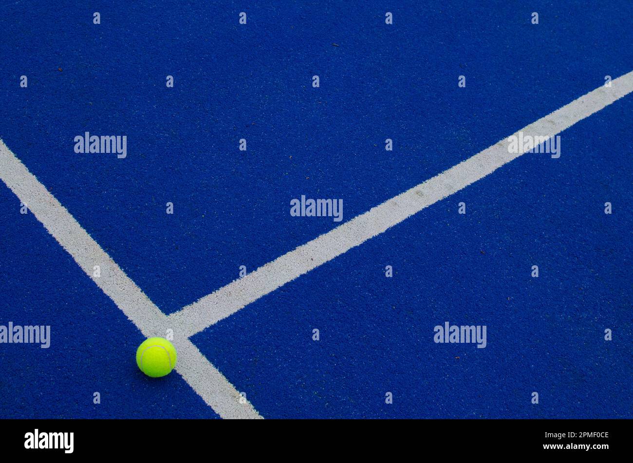 top view of a ball on the lines of a blue paddle tennis court Stock