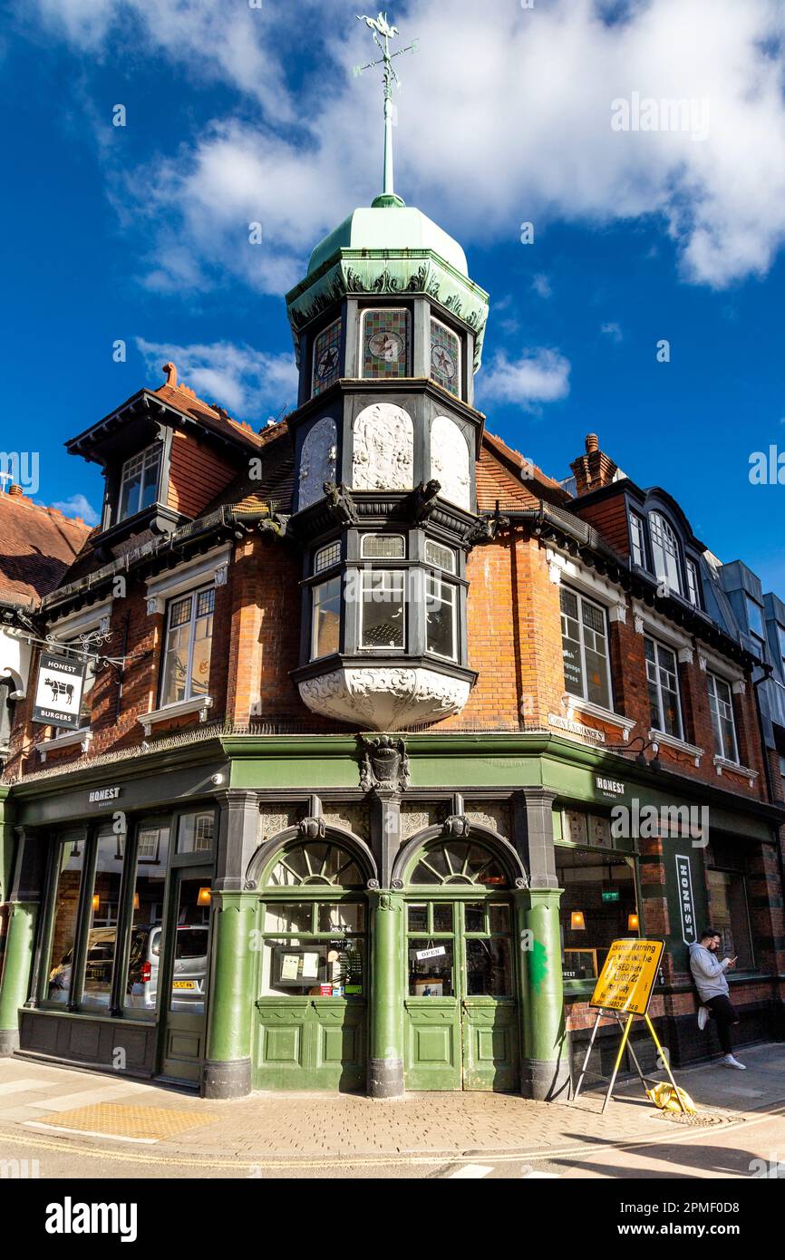 Historic building with a turret, hosing Honest Burger restaurant, Corn Exchange Street, Cambridge, Cambridgeshire, UK Stock Photo