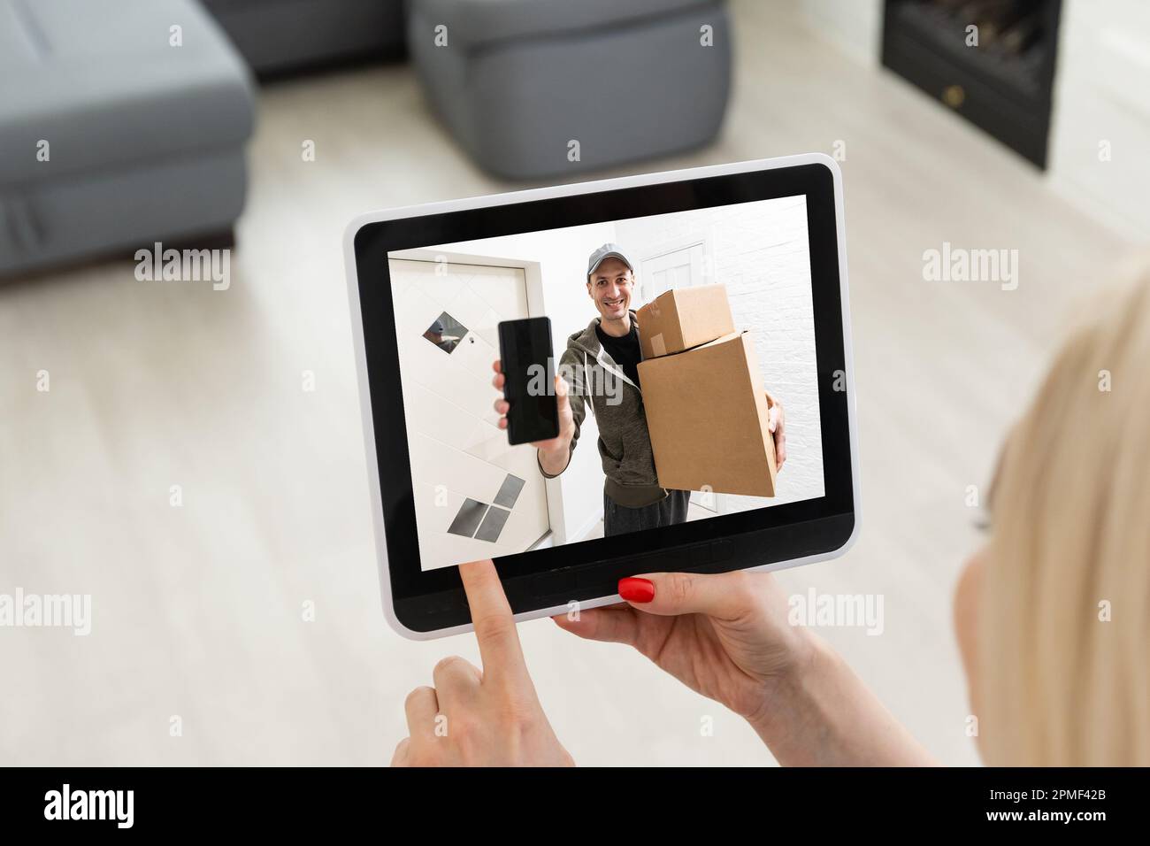 Delivery Man Using Remote the delivery man rings the doorbell on the monitor of the security ...