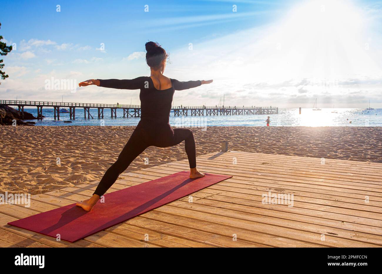 France, Vendee, Noirmoutier island, Noirmoutier en l'Ile, Ashtanga Yoga teacher in training near the landing stage of the Ladies beach, at sunrise Stock Photo