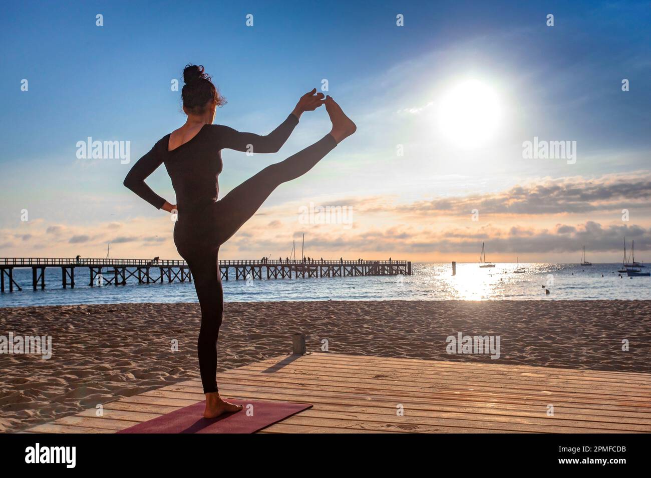 France, Vendee, Noirmoutier island, Noirmoutier en l'Ile, Ashtanga Yoga teacher in training near the landing stage of the Ladies beach, at sunrise Stock Photo