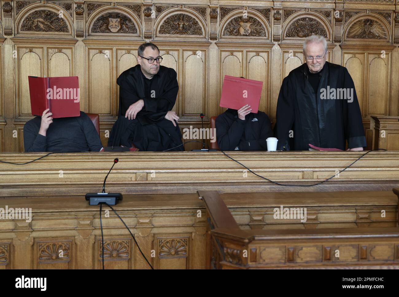 Bremen, Germany. 13th Apr, 2023. Two defendants wait with their defense