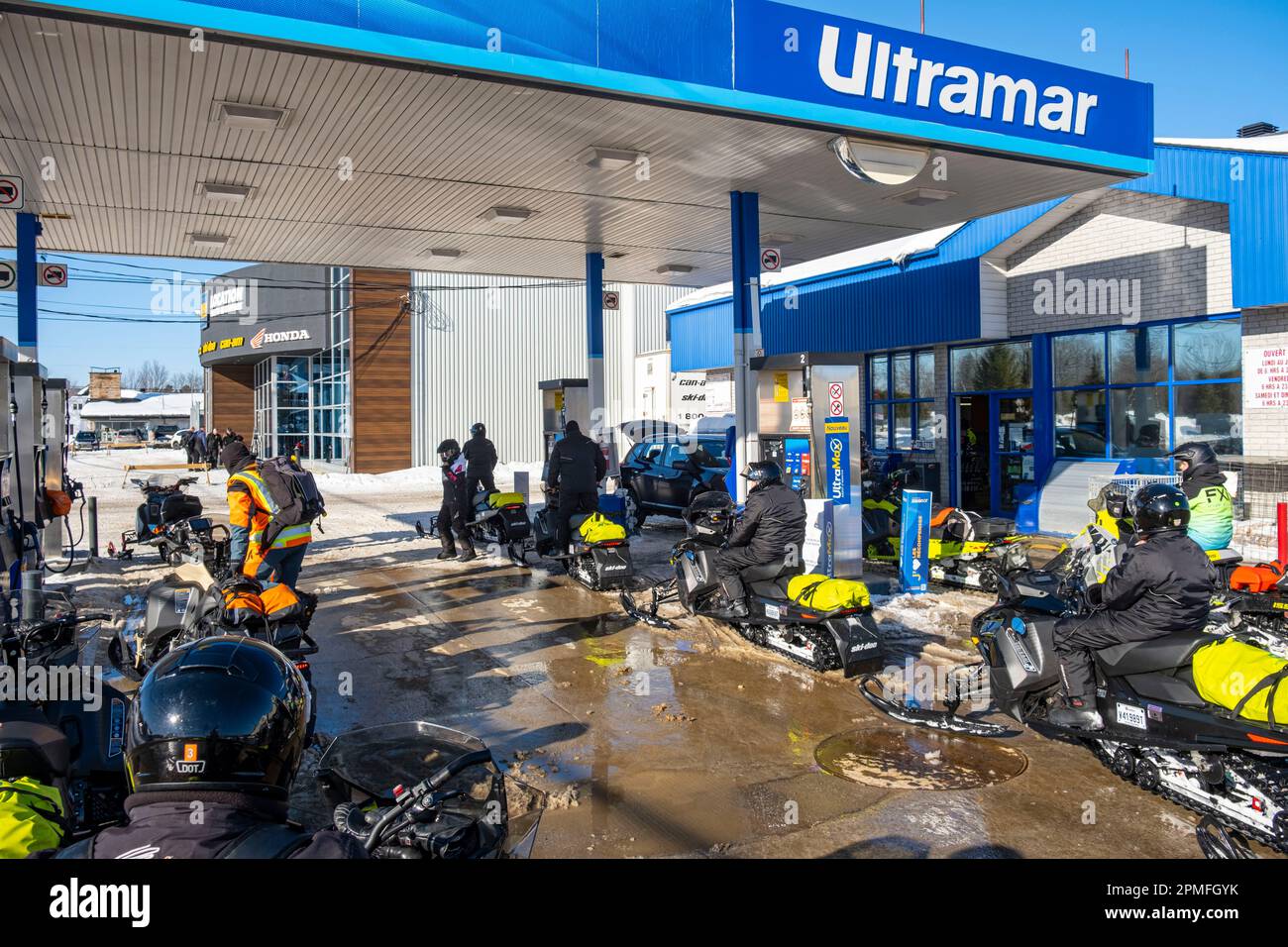 Canada, Quebec Province, Saint Michel des Saints, service station, snowmobiles fill up with gas Stock Photo