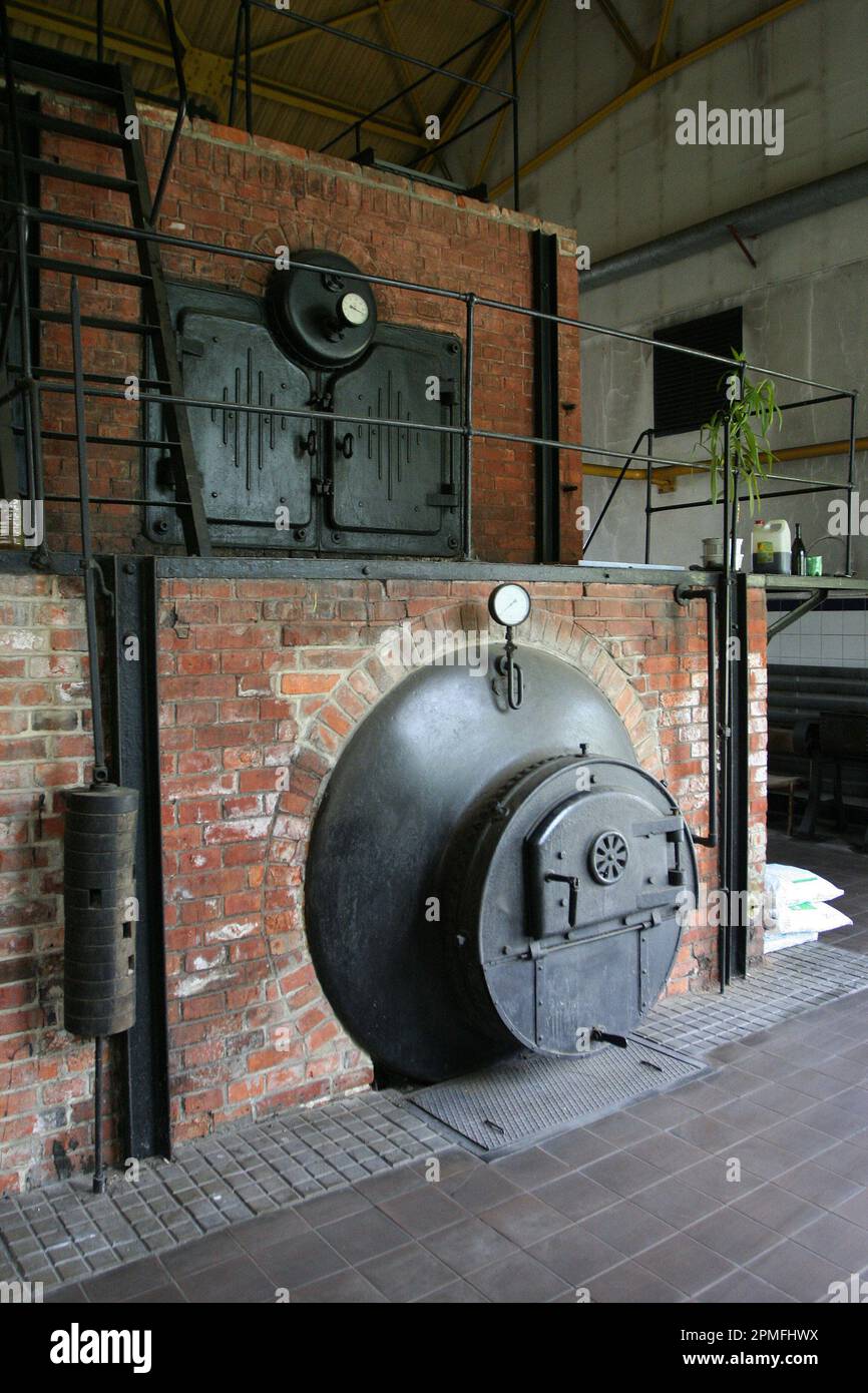 Old brick made central heating coal burning furnace. Stock Photo