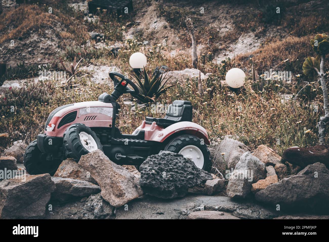 Broken toy tractor abandoned on hillside Stock Photo Alamy