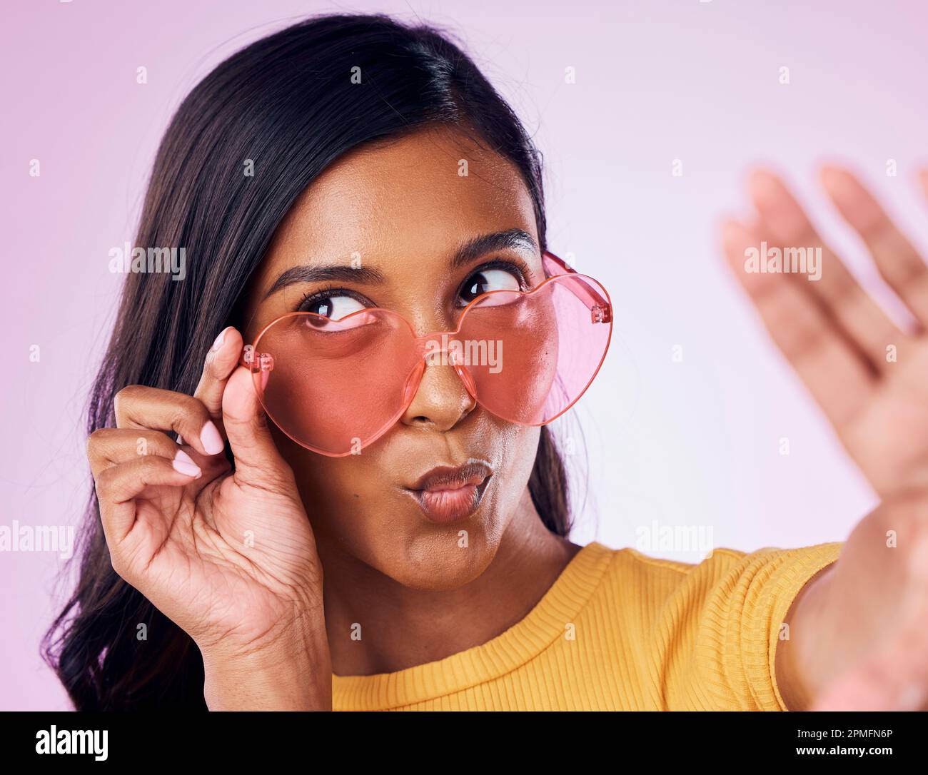 Selfie, heart and sunglasses by indian woman in studio emoji, cool and