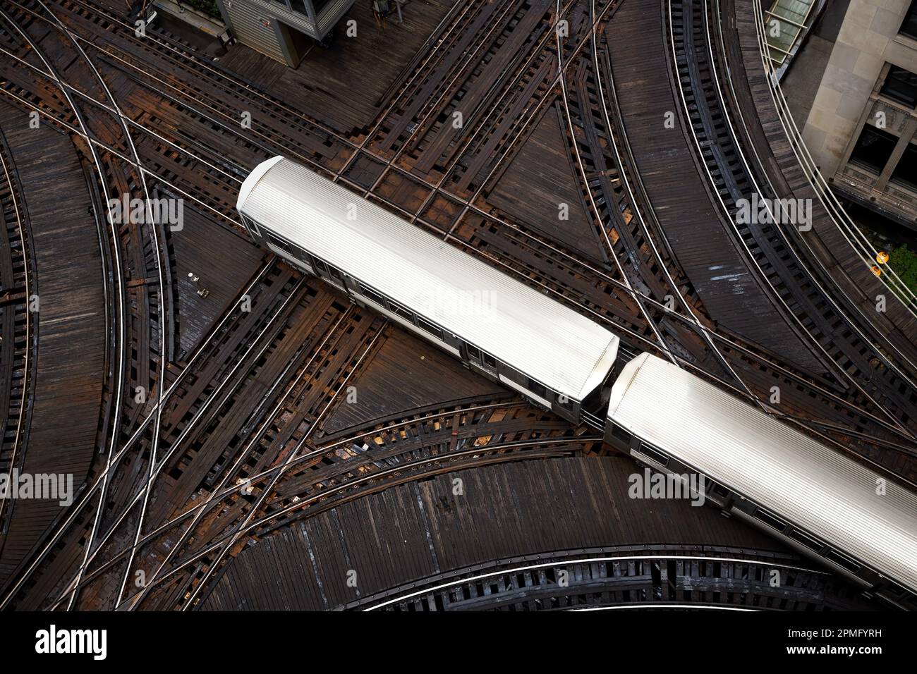 High angle view of passenger train on junction. Elevated railroad track in Chicago downtown. Stock Photo