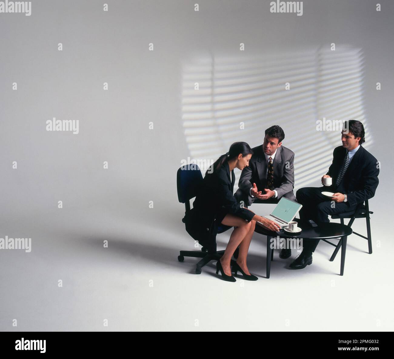 Business. Three executives sitting in informal meeting Stock Photo - Alamy