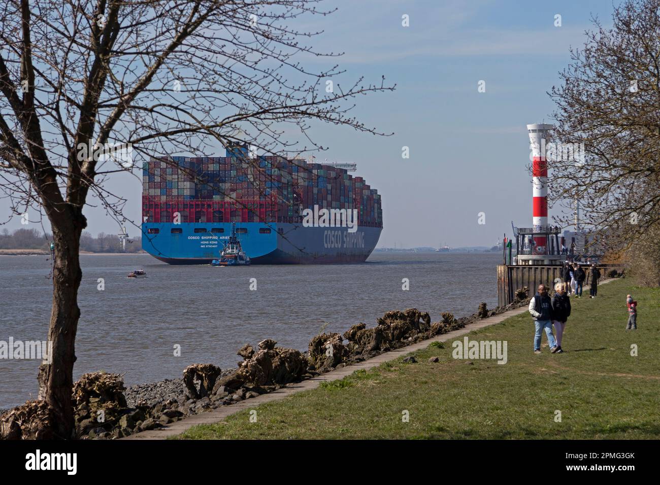 Cosco Shipping container ship, towboat, Elbe, people, lighthouse, Blankenese, Hamburg, Germany Stock Photo