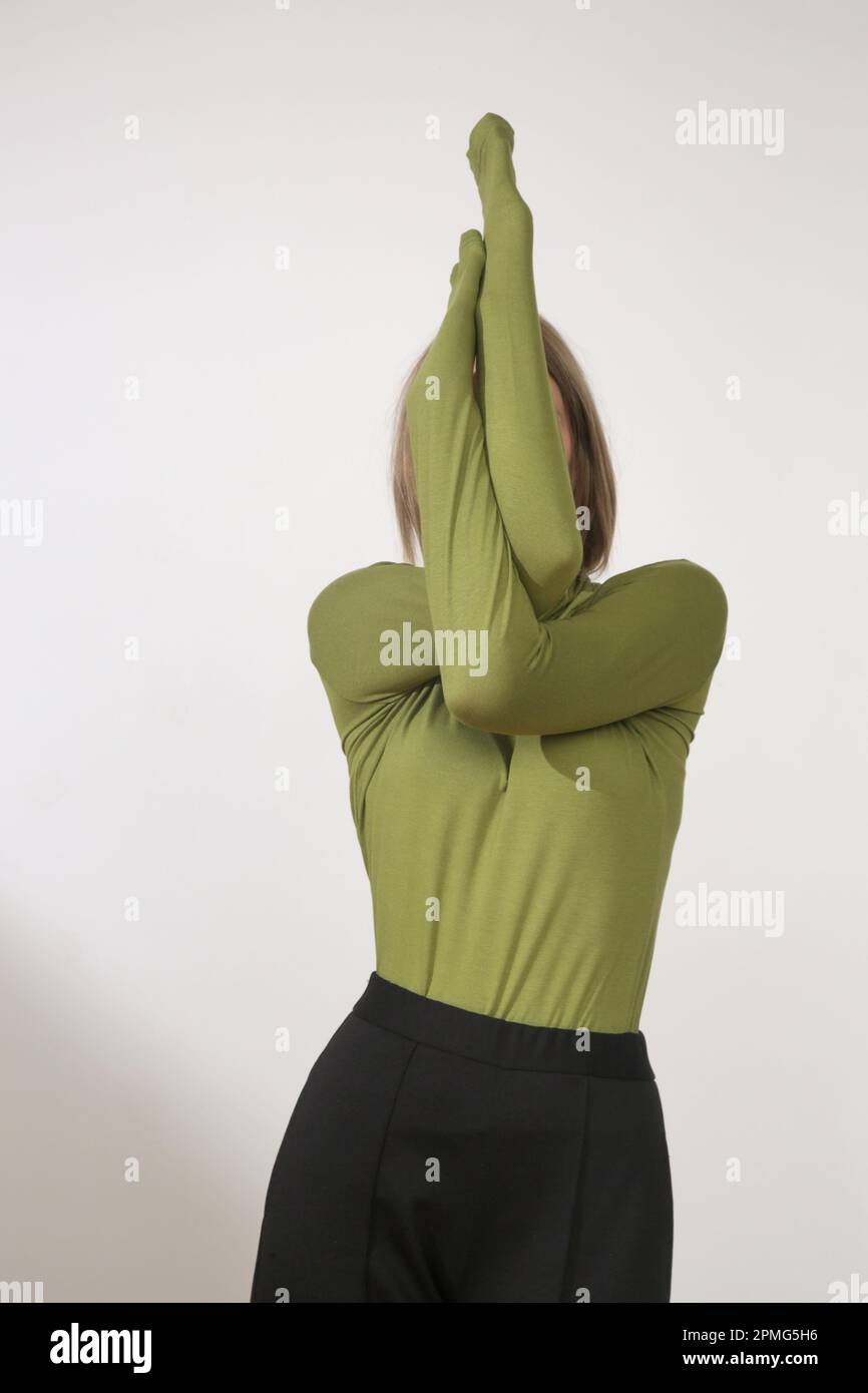 Serie of studio photos of young female model wearing comfortable basic outfit, viscose fitted turtleneck shirt and basic cigarette trousers Stock Photo