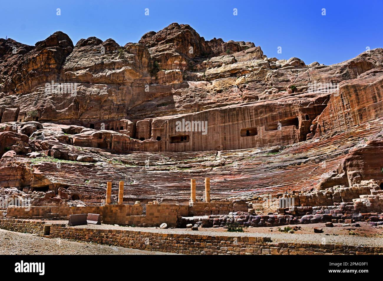 Roman Theatre Petra city Nabataean caravan-city rock-cut façades Jordan carved sandstone rock desert. Stock Photo