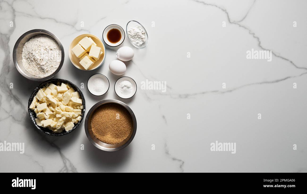 Blondie ingredients on white marble background. White chocolate with