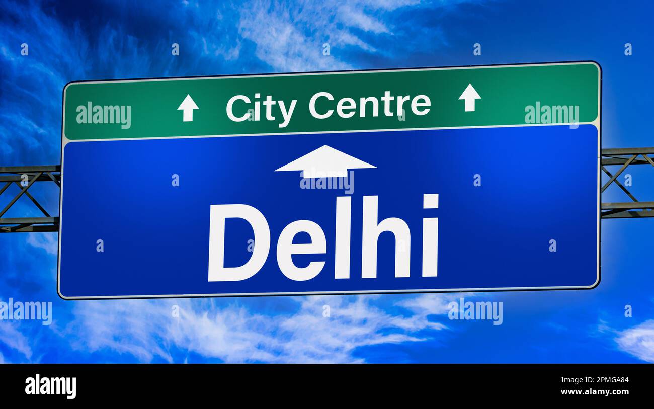 Road sign indicating direction to the city of Delhi. Stock Photo
