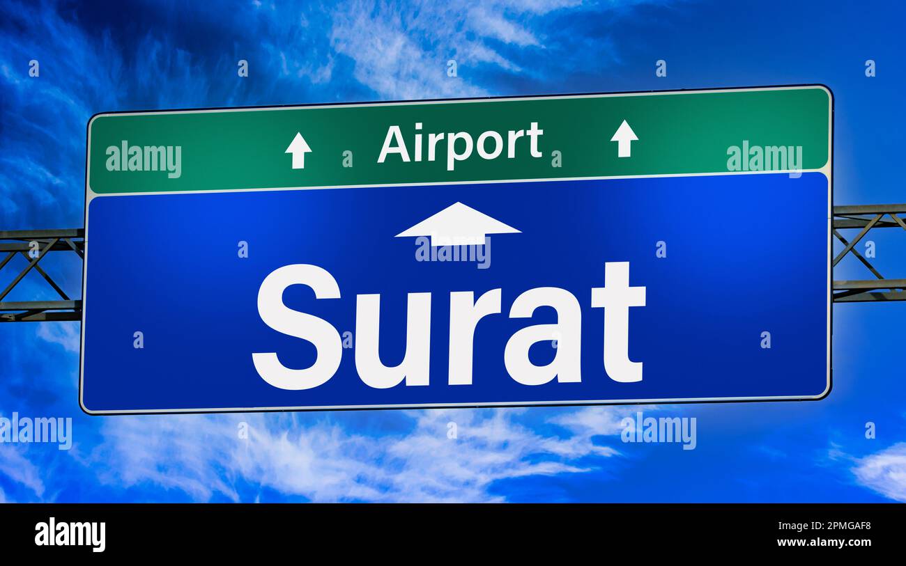 Road sign indicating direction to the city of Surat. Stock Photo
