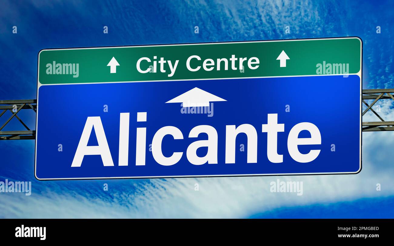 Road sign indicating direction to the city of Alicante. Stock Photo