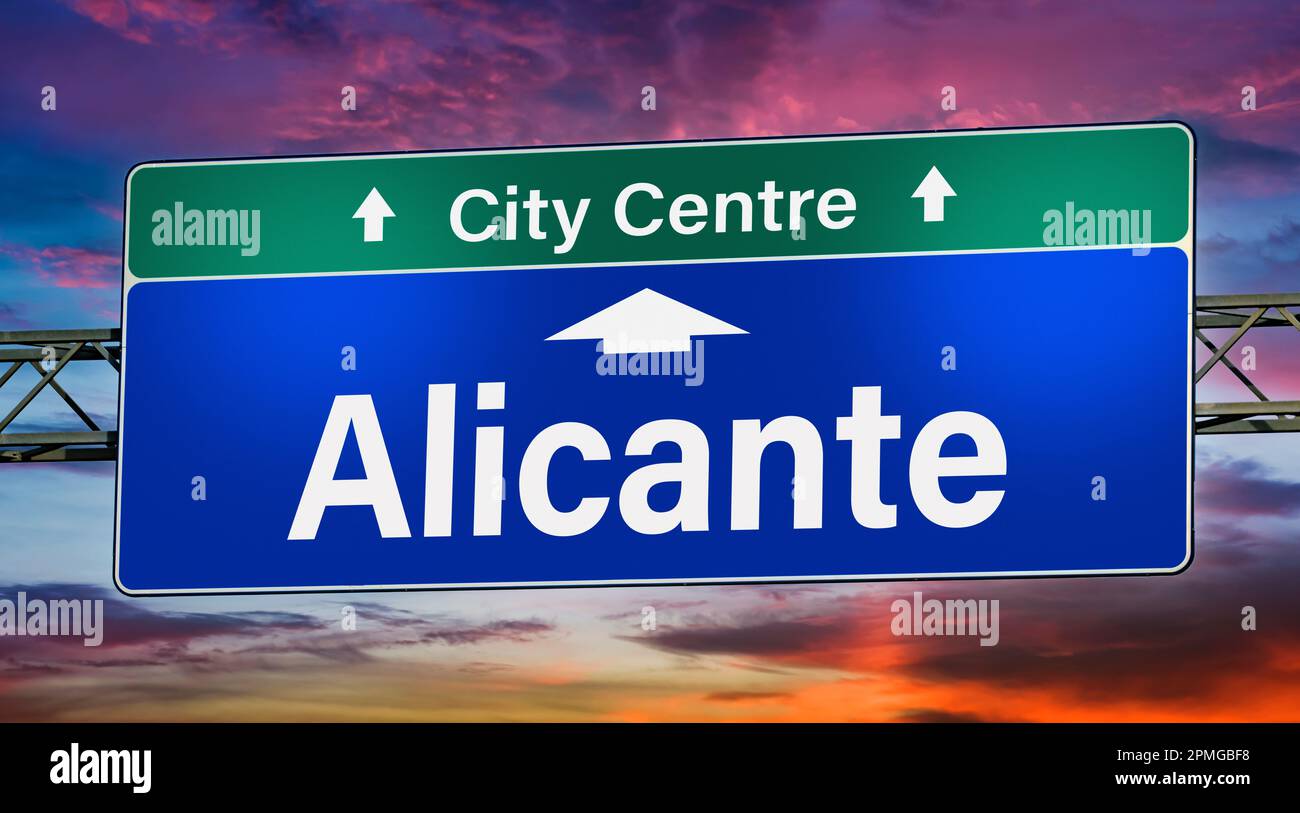 Road sign indicating direction to the city of Alicante. Stock Photo