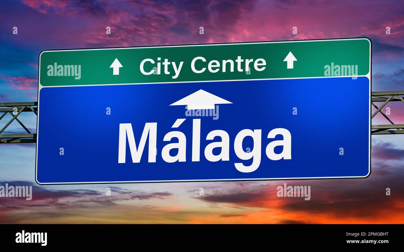 Road sign indicating direction to the city of Malaga Stock Photo Alamy