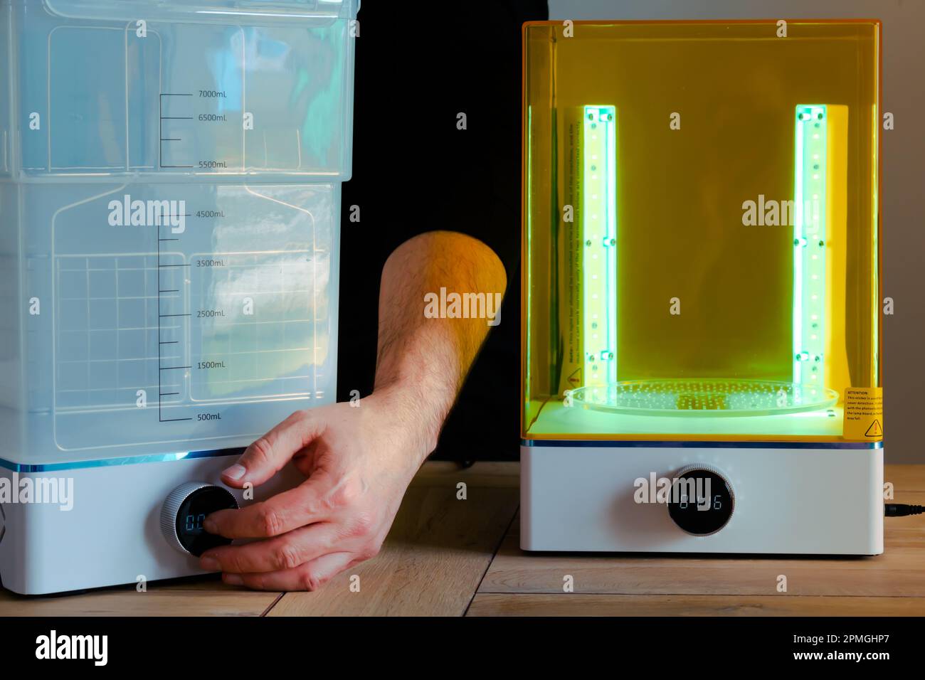 Man adjusting a wash and cure machine using UV light before use, for 3d  resin printer Stock Photo - Alamy