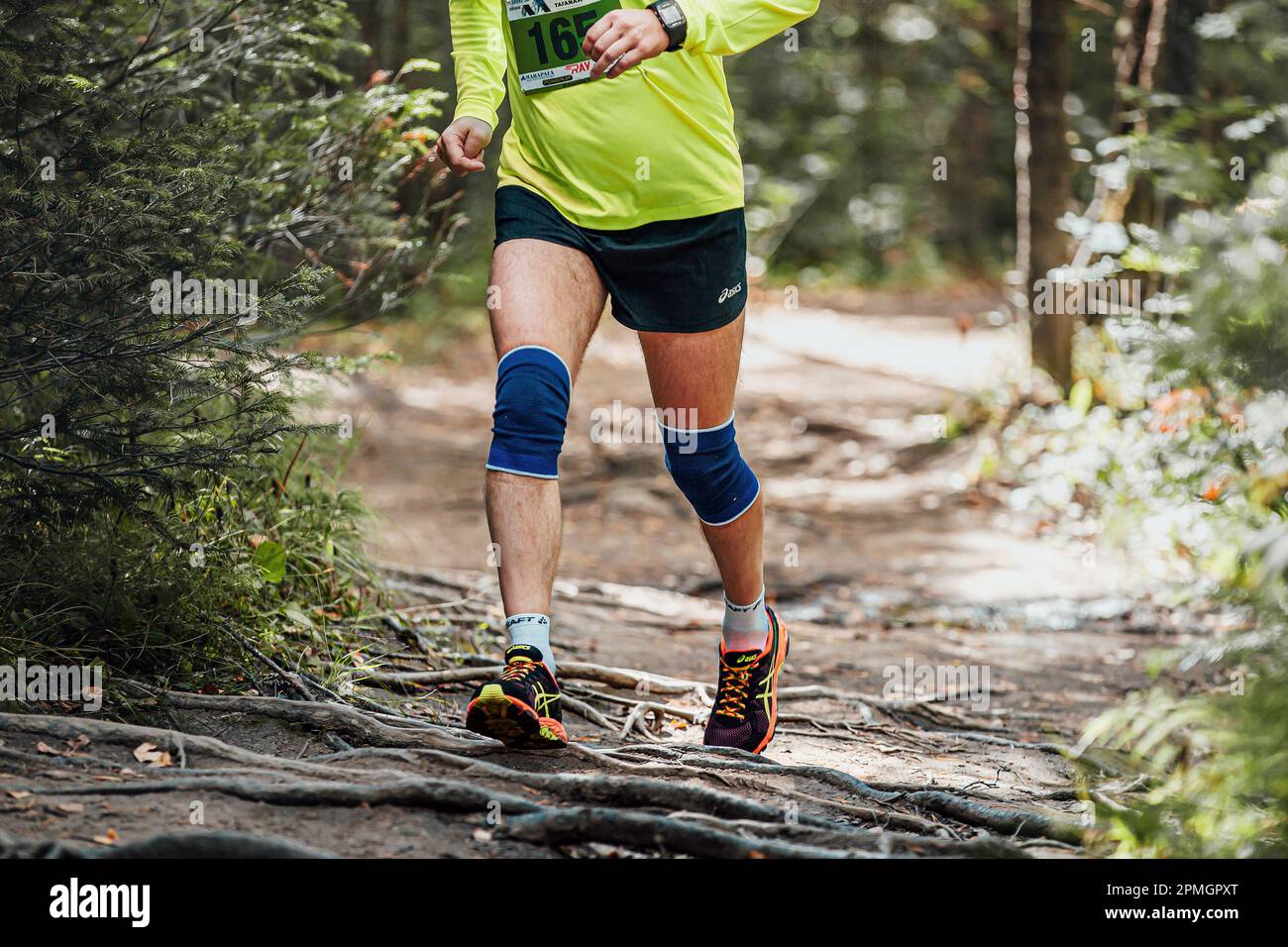 Zlatoust, Russia - August 2016: male runner run forest trail marathon in Asics shorts and running shoes Stock Photo - Alamy