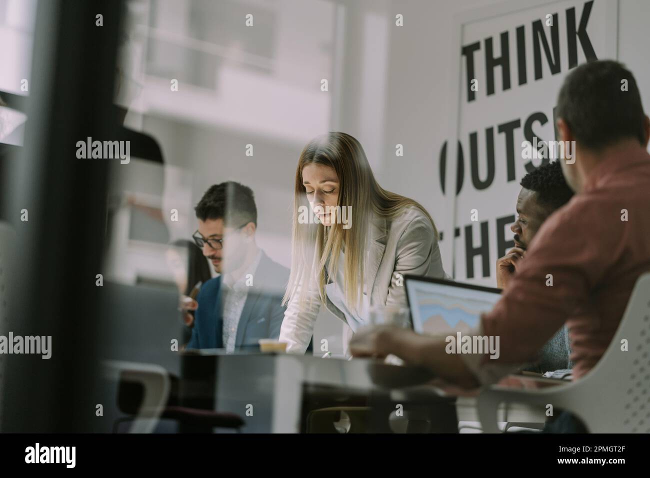 A group of diverse people co working in a modern co working space ...