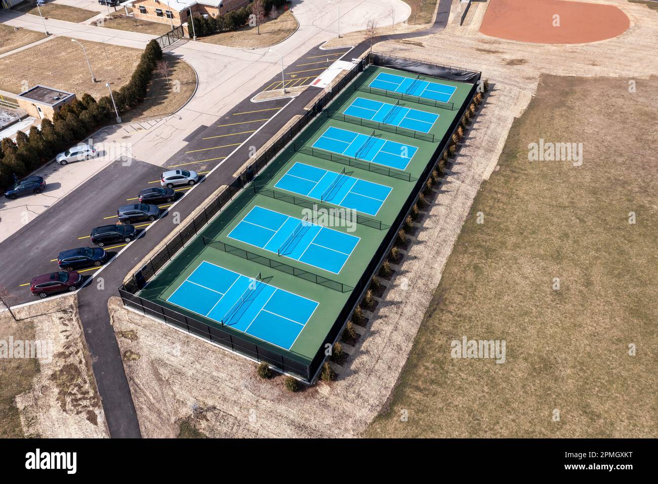 Aerial view of a new pickleball facility with blue and green courts in