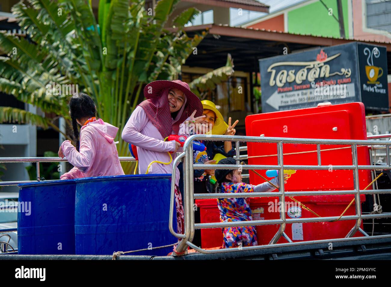 April 13 2023-Thung Wua Laen Beach - Chumphon area: Crowds celebrate Songkran, Thai New Year, by splashing each other with colored water or painting e Stock Photo