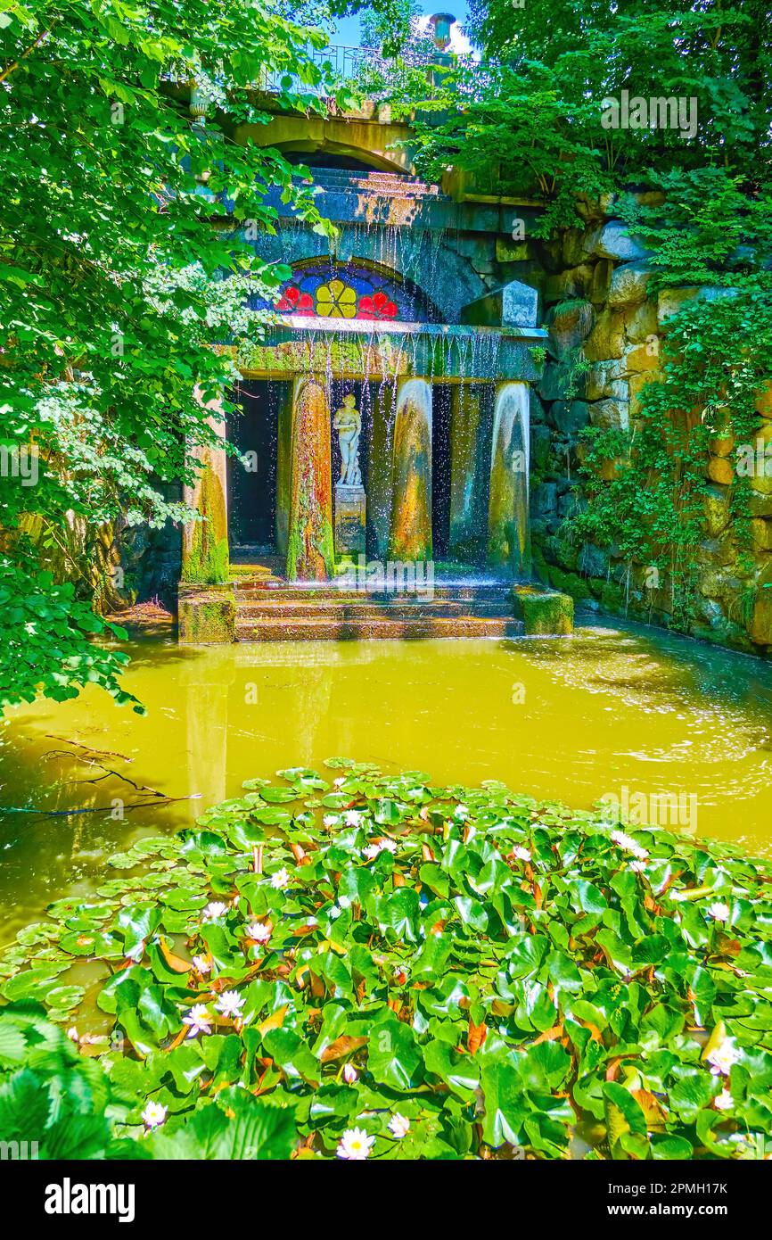 The narrow river with water lilies and Grotto of Venus on background in ...