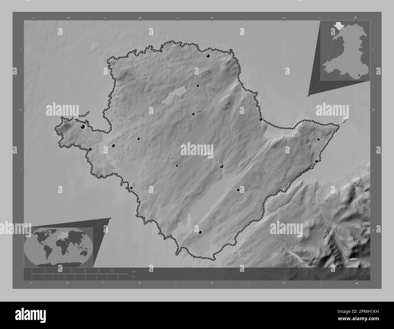 Isle Of Anglesey, region of Wales - Great Britain. Grayscale elevation map with lakes and rivers. Locations of major cities of the region. Corner auxi Stock Photo