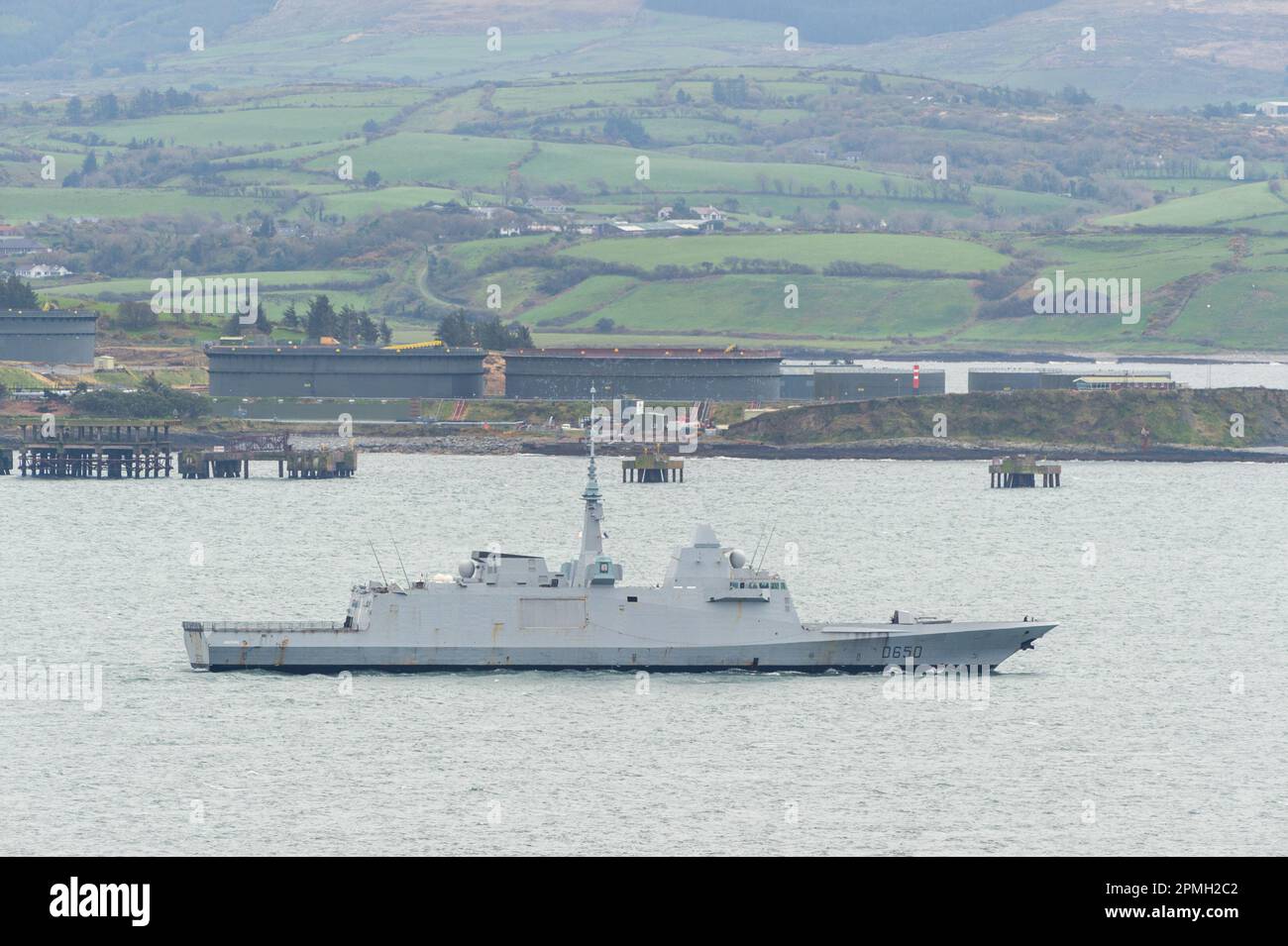 Glengarriff, West Cork, Ireland. 13th Apr, 2023. The French NATO frigate 'Aquitaine', which had been sheltering in Bantry Bay, off Glengarriff, has sailed out to sea. The warship changed her course from Oslo, Norway to an undisclosed location on Monday to shelter from Storm Noa, which hit the region on Wednesday. The ship sails past the oil terminals on Whiddy Island. Credit: AG News/Alamy Live News Stock Photo
