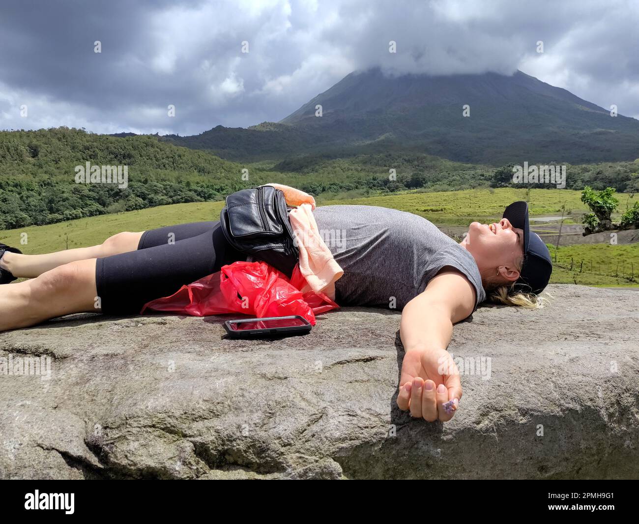 Arenal Volcano National Park, Costa Rica - A hiker relaxes after completing a hike on the Arenal volcano. Stock Photo