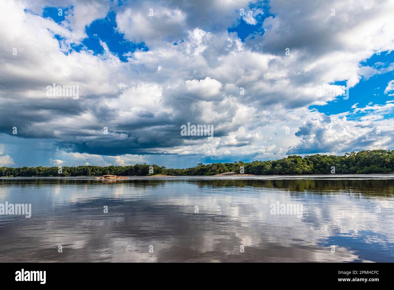 Reflections of clouds in the Casiquiare River in the deep south of Venezuela, South America Stock Photo
