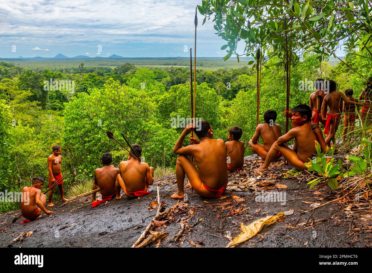 Yanomami tribe sitting on a giant rock in the jungle, southern Venezuela, South America Stock Photo