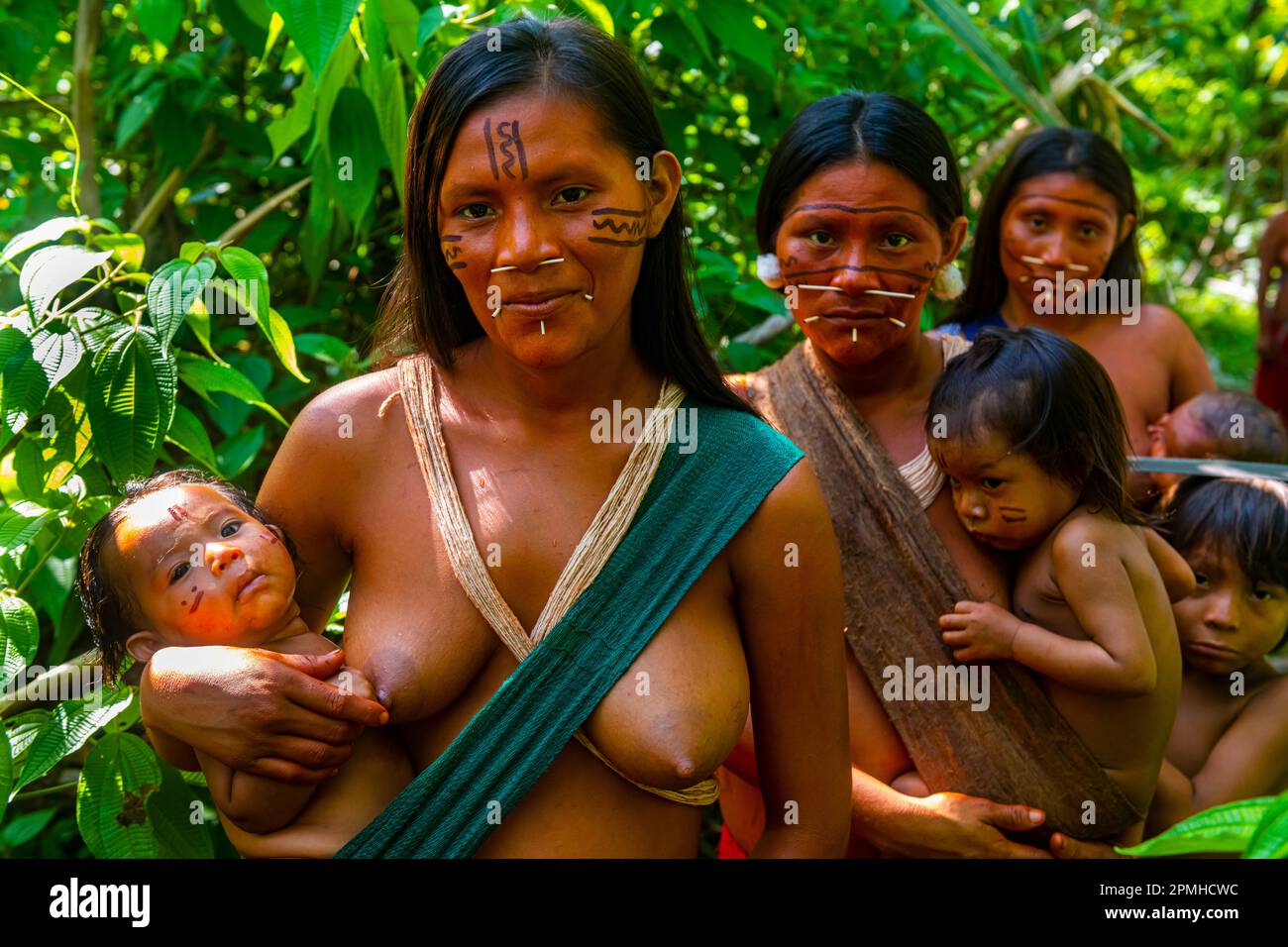 Women with their babies from the Yanomami tribe standing in the jungle, southern Venezuela, South America Stock Photo