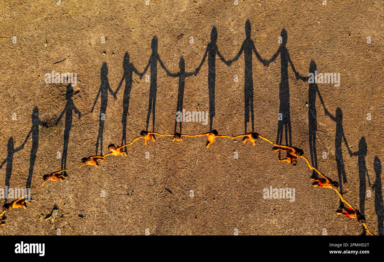 Yanomami children lining up creating a circle, and shadows, Yanomami tribe, southern Venezuela, South America Stock Photo