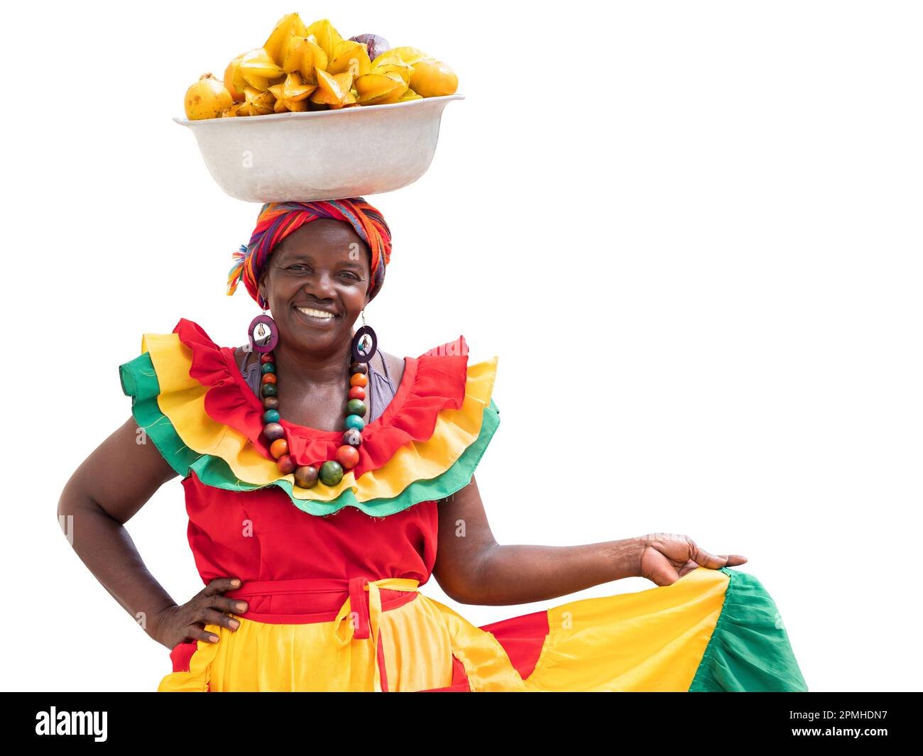 Happy fresh fruit street vendor, Palenquera, isolated on white background. Cheerful Afro-Colombian woman in traditional costumes, Cartagena, Colombia. Stock Photo