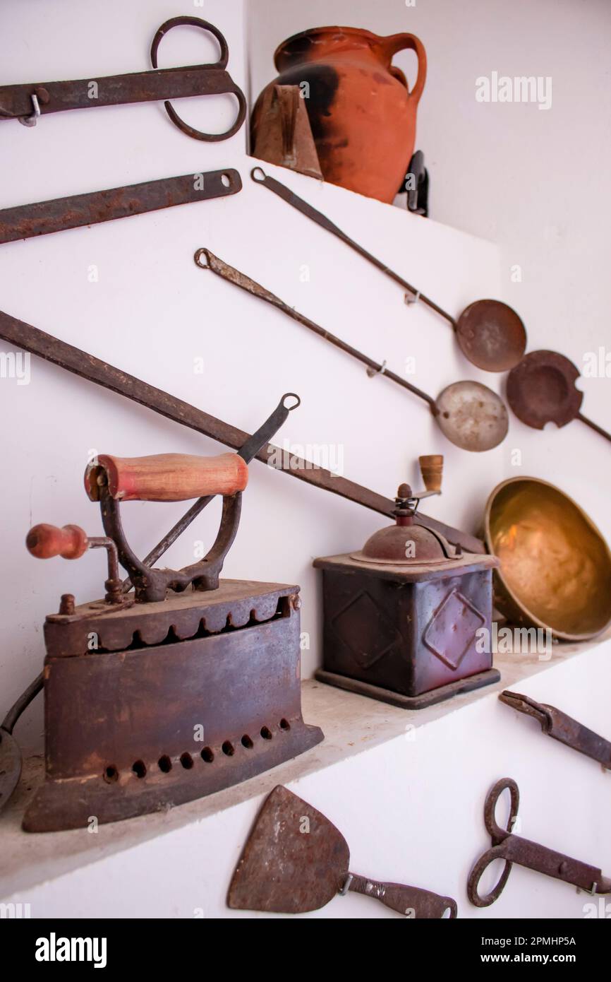 Antique clothes iron and coffee grinder, along with other different antiques Stock Photo