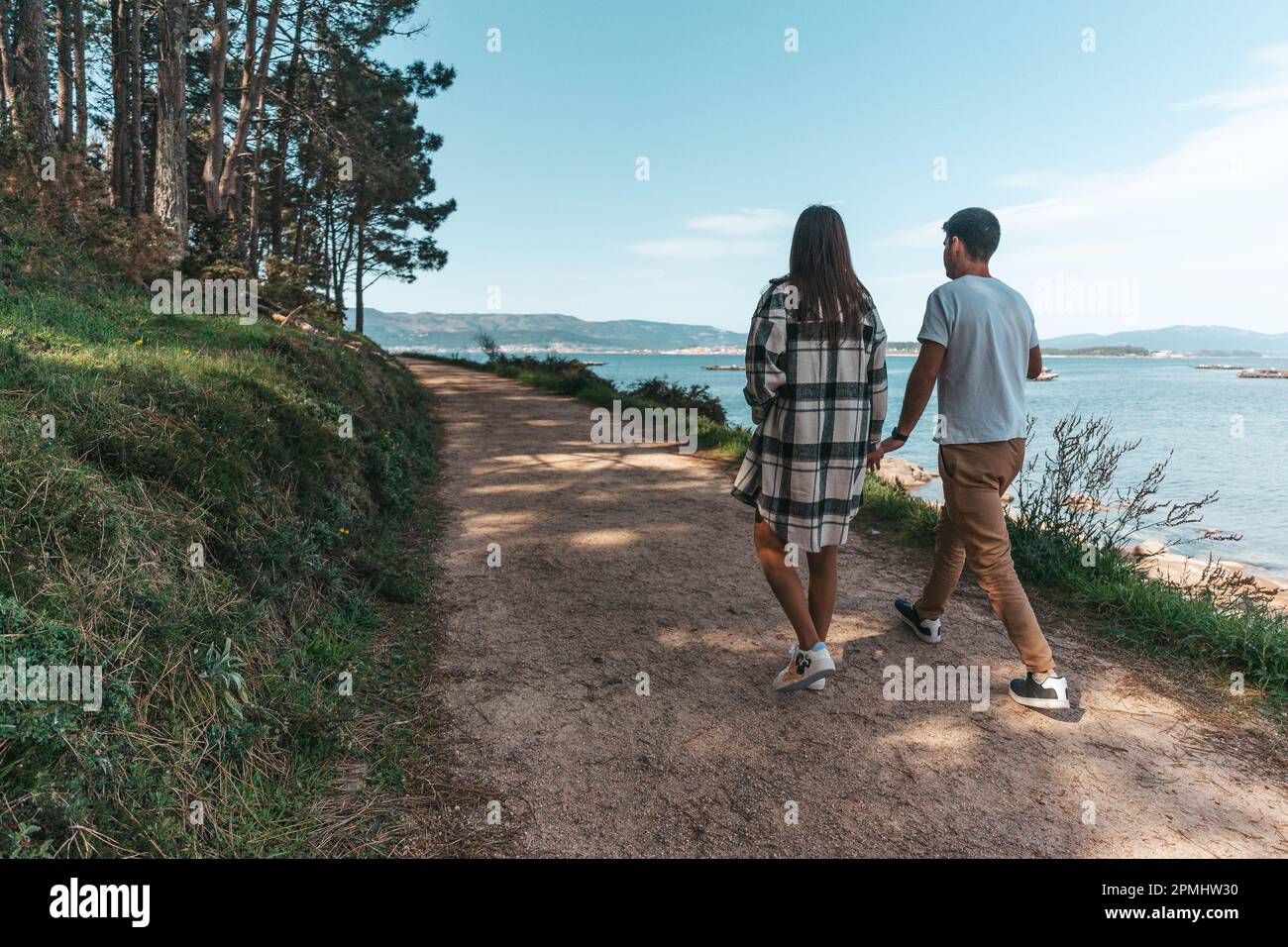Young couple taking a walk near the ocean in Galicia, Spain Stock Photo