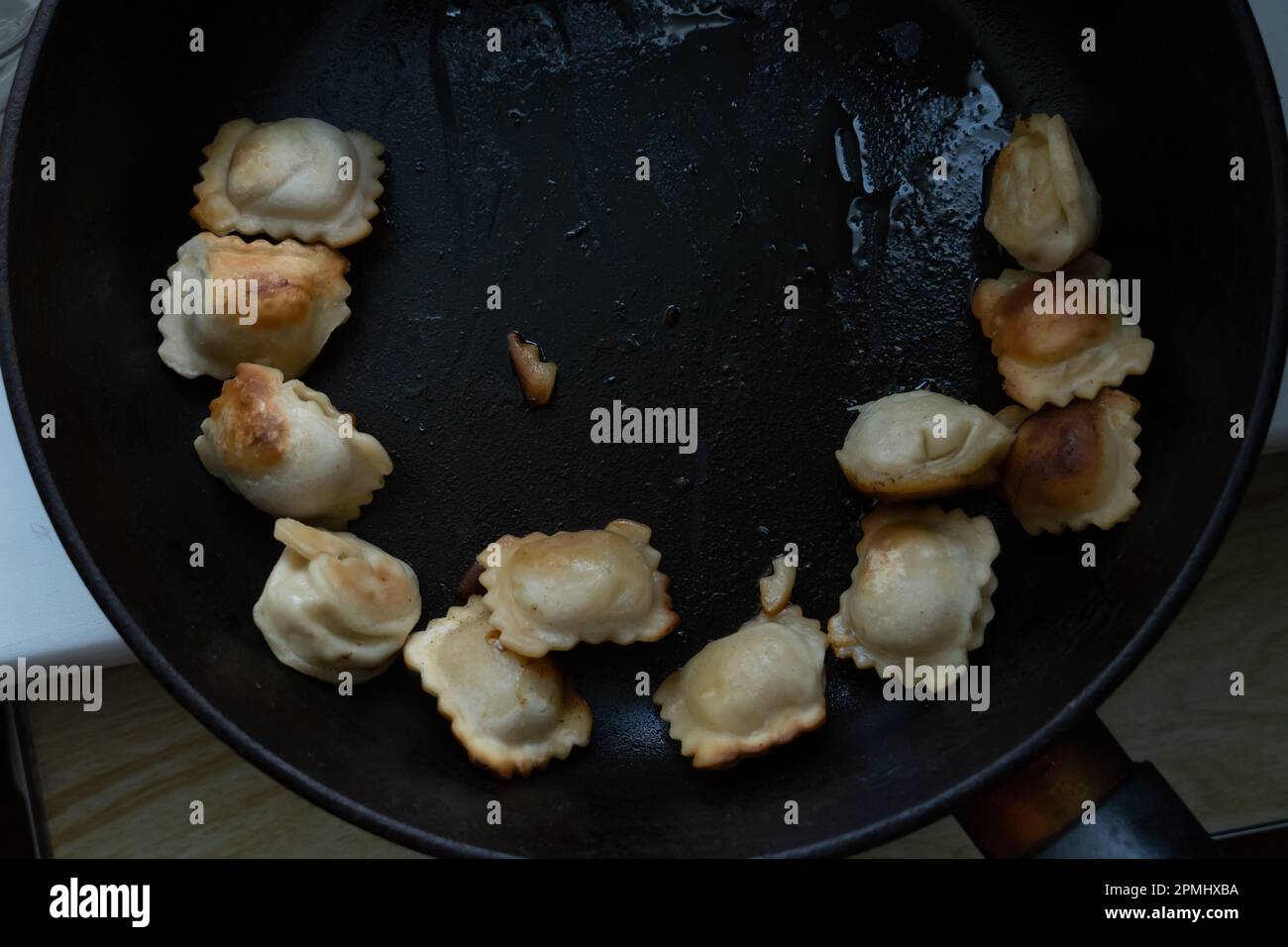 Fried dumplings in a black frying pan harmful food Stock Photo Alamy