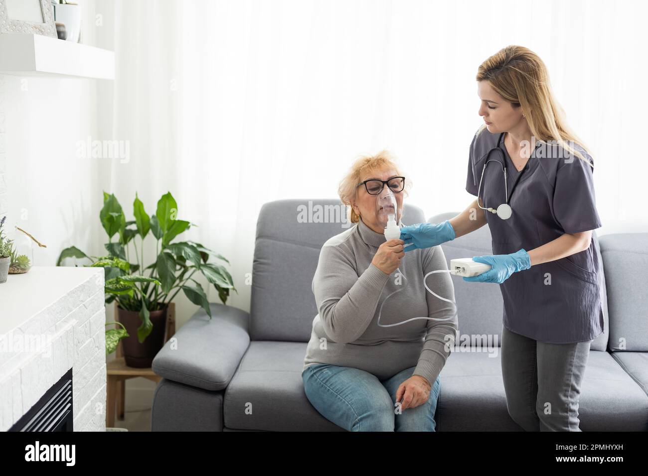 Elderly woman using inhaler for asthma and respiratory diseases at home