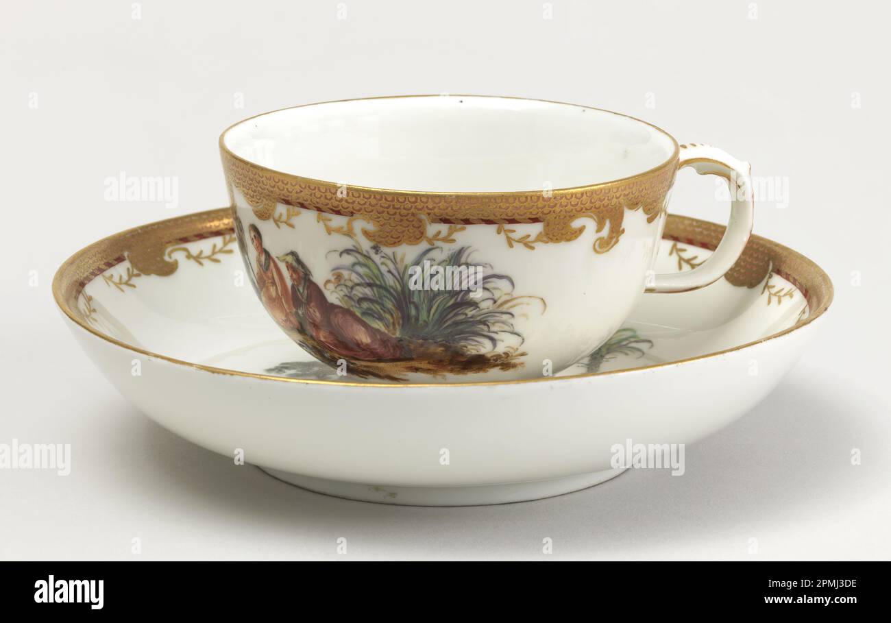 Cup and Saucer with Chinoiserie Vignettes Cup And Saucer; Manufactured by Royal Porcelain Manufactory, Berlin (Germany); Style of Jacques-Gabriel Huquier (French, 1730 - 1805), François Boucher (French, 1703–1770); Germany; hard paste porcelain, vitreous enamel, gold Stock Photo